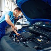 worker-in-uniform-checks-engine-car-service-small-qsdeyzq0k2ku31sx1ymzdzx974li1v892fktjim1og